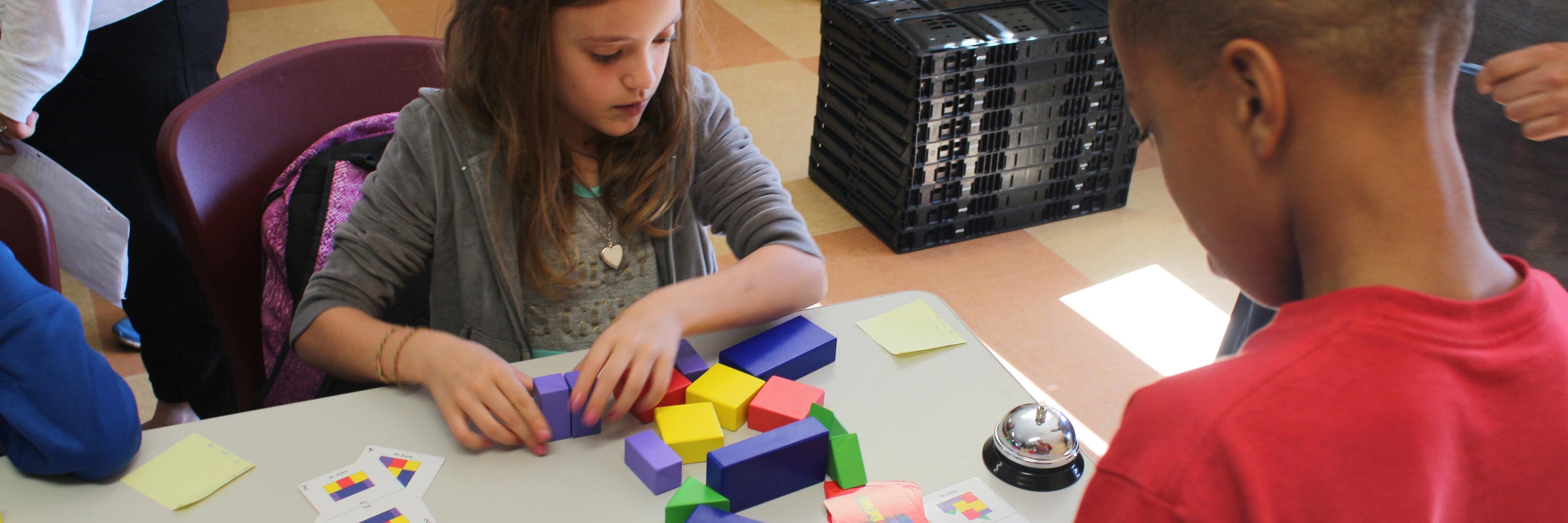 two children playing with building blocks