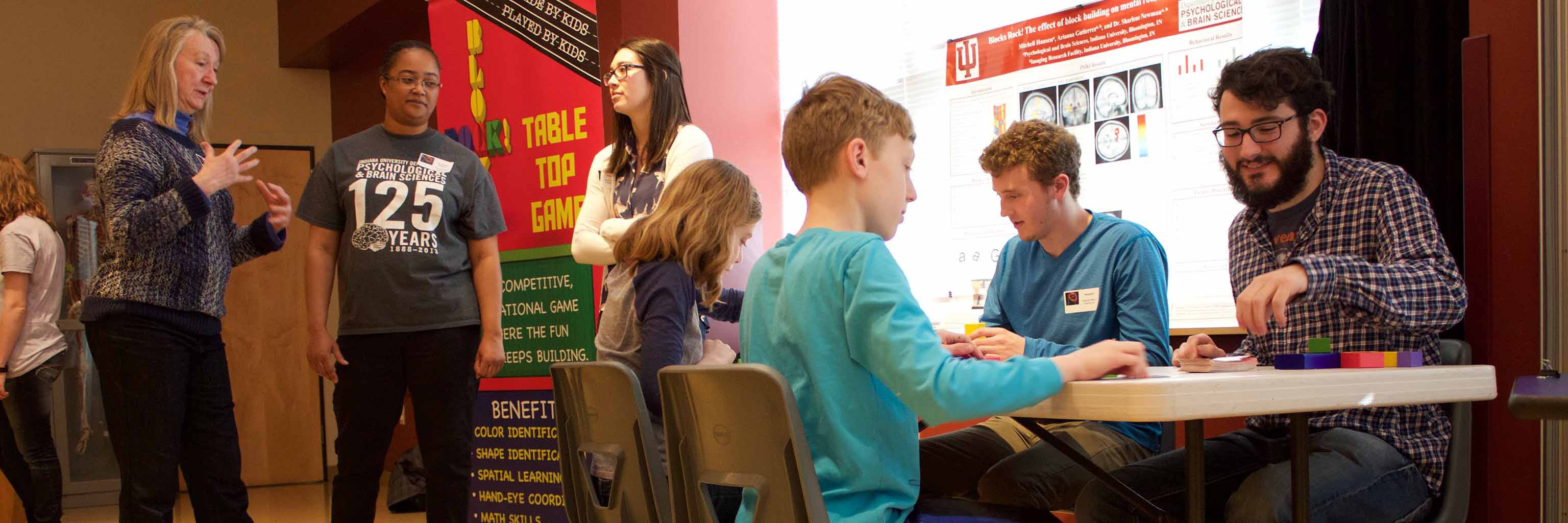 students and faculty interact with children at an event