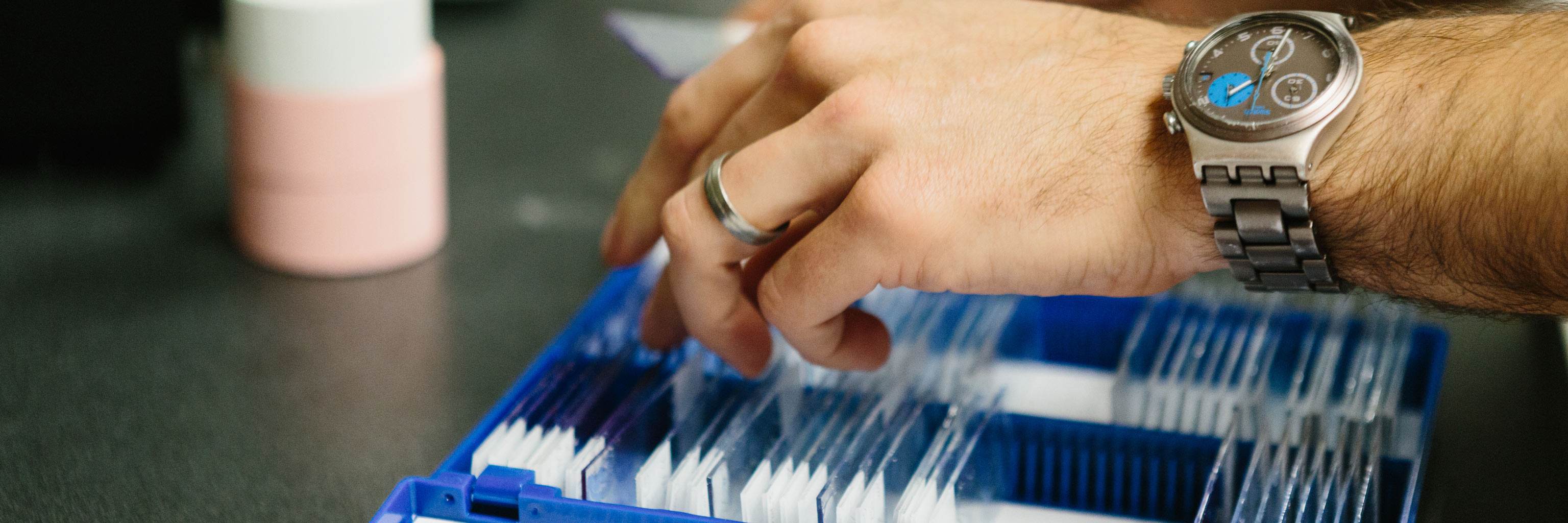 hand searching through glass slides