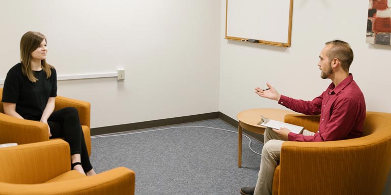 woman being interviewed by man